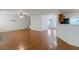 Open-concept living room with hardwood floors, flowing into the dining area and kitchen at 11354 Conner Ct, Hampton, GA 30228