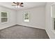 Bright bedroom features neutral carpet, a ceiling fan, and natural light at 1508 Franklin Cir, Dacula, GA 30019