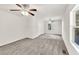 Large bedroom with neutral carpet, two ceiling fans, and natural light at 1508 Franklin Cir, Dacula, GA 30019
