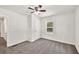 Bedroom with neutral carpet, ceiling fan, window, and a closet at 1508 Franklin Cir, Dacula, GA 30019