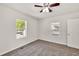 Bedroom with neutral carpet, ceiling fan, window, and a closet at 1508 Franklin Cir, Dacula, GA 30019