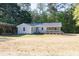 Beautiful single-story home with a charming front porch, set against a backdrop of lush greenery at 1508 Franklin Cir, Dacula, GA 30019