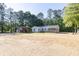 A full view of the house, garage, and carport with front yard at 1508 Franklin Cir, Dacula, GA 30019