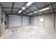 Spacious garage featuring durable metal construction, roll-up doors, and ample lighting for versatile use at 1508 Franklin Cir, Dacula, GA 30019