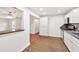Well-lit kitchen featuring stainless steel appliances, granite countertops, and seamlessly flowing wood flooring at 1508 Franklin Cir, Dacula, GA 30019