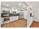 Modern kitchen with stainless steel appliances, granite countertops, and wood flooring at 1508 Franklin Cir, Dacula, GA 30019
