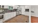 Stylish kitchen with stainless appliances, granite counters, and beautiful wood floors at 1508 Franklin Cir, Dacula, GA 30019