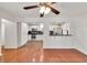 Open concept living room and kitchen featuring hardwood floors and a breakfast bar at 1508 Franklin Cir, Dacula, GA 30019
