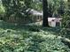 Charming home with unique architectural design nestled amongst mature trees and lush greenery at 181 Eureka Ne Dr, Atlanta, GA 30305