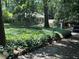 Lush greenery surrounds this home with unique architectural details nestled amongst mature trees at 181 Eureka Ne Dr, Atlanta, GA 30305