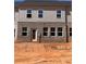 Townhome's rear exterior features brick and siding, complemented by a door and several windows at 3106 Marbella Cir # 3, Kennesaw, GA 30152