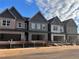 View of newly constructed townhomes featuring brick exteriors and attached garages under a blue sky at 3106 Marbella Cir # 3, Kennesaw, GA 30152