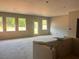 Unfinished living room featuring large windows, providing ample natural light and views of the outdoors at 3106 Marbella Cir # 3, Kennesaw, GA 30152