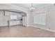 Bright kitchen with white cabinets and tile floors open to dining area at 392 Vine St, Atlanta, GA 30314