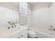 Bright bathroom featuring a shower and tub, white tile, and vanity with modern fixtures at 5034 Hickory Hills Dr, Woodstock, GA 30188