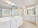 Bright main bathroom with dual sinks, lots of mirror, and a large vanity at 5034 Hickory Hills Dr, Woodstock, GA 30188