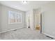 Bright bedroom with neutral carpet, light paint and two closet openings at 5034 Hickory Hills Dr, Woodstock, GA 30188