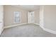 Spacious bedroom features light-filled room with neutral carpet and paint at 5034 Hickory Hills Dr, Woodstock, GA 30188