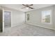 This bedroom features a ceiling fan and two windows that provide ample natural light at 5034 Hickory Hills Dr, Woodstock, GA 30188