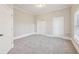 Bright bedroom with neutral paint and carpet with view of window and closet at 5034 Hickory Hills Dr, Woodstock, GA 30188