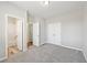 Bright bedroom features neutral gray paint, plush carpet, and access to a private bathroom and closet at 5034 Hickory Hills Dr, Woodstock, GA 30188