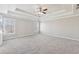 Spacious bedroom featuring a tray ceiling, neutral carpet and light paint, and large windows at 5034 Hickory Hills Dr, Woodstock, GA 30188