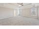 Large main bedroom with tray ceiling, ceiling fan, and neutral carpet and paint at 5034 Hickory Hills Dr, Woodstock, GA 30188
