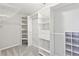 Well organized closet with white painted shelving and railing at 5034 Hickory Hills Dr, Woodstock, GA 30188
