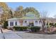 Charming clubhouse with a green roof, neutral siding, and manicured landscaping at 5034 Hickory Hills Dr, Woodstock, GA 30188