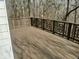 Outdoor deck with decorative wood railings and a view of mature trees at 5034 Hickory Hills Dr, Woodstock, GA 30188