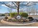 Community entrance sign surrounded by manicured landscaping, providing a welcoming first impression at 5034 Hickory Hills Dr, Woodstock, GA 30188