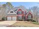 Beautiful two-story home boasts a brick facade, two-car garage, and meticulously maintained landscaping at 5034 Hickory Hills Dr, Woodstock, GA 30188