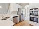 Modern kitchen complete with stainless steel appliances, quartz countertops, and ample cabinet space at 5034 Hickory Hills Dr, Woodstock, GA 30188