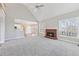 Open living room with a brick fireplace and view into the kitchen at 5034 Hickory Hills Dr, Woodstock, GA 30188