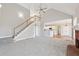 Open-concept living room features a staircase and flows into the kitchen at 5034 Hickory Hills Dr, Woodstock, GA 30188