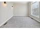 Bright living room features new carpet and a large window at 5034 Hickory Hills Dr, Woodstock, GA 30188