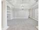 Spacious open living room with decorative columns and a modern light fixture at 5034 Hickory Hills Dr, Woodstock, GA 30188