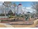 Community playground featuring slides, climbing structures, and a soft landing surface near the pool at 5034 Hickory Hills Dr, Woodstock, GA 30188