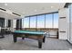 Spacious game room featuring a pool table, high-top tables, and city views at 855 Peachtree Ne St # 3005, Atlanta, GA 30308