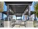 Outdoor kitchen featuring a professional-grade grill and a covered dining area at 855 Peachtree Ne St # 3005, Atlanta, GA 30308