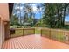 Inviting wood deck overlooks a spacious backyard with mature trees and a swing set, perfect for outdoor relaxation and play at 1753 Pounds Rd, Stone Mountain, GA 30087