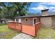 Back of the house with brick facade and a wooden deck providing an outdoor space for relaxation and enjoying the backyard at 1753 Pounds Rd, Stone Mountain, GA 30087
