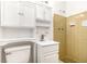 Compact bathroom featuring retro tile, modern sink, and storage space at 1753 Pounds Rd, Stone Mountain, GA 30087