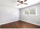 Cozy bedroom featuring hardwood floors, a ceiling fan, and natural light at 1753 Pounds Rd, Stone Mountain, GA 30087