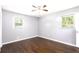 Spacious bedroom featuring hardwood floors, two windows, and ample natural light at 1753 Pounds Rd, Stone Mountain, GA 30087