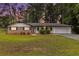 Charming single-story home with brick facade, manicured lawn, and attached two-car garage at 1753 Pounds Rd, Stone Mountain, GA 30087