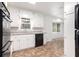 Clean kitchen featuring white cabinets and countertops, modern appliances, and tiled floors at 1753 Pounds Rd, Stone Mountain, GA 30087