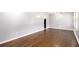 An open-concept living room featuring gleaming hardwood floors, fresh paint, and lots of sunlight at 1753 Pounds Rd, Stone Mountain, GA 30087