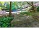 Stone pathway with lush greenery leading to a pool, creating a serene backyard setting at 1760 Little Willeo Rd, Marietta, GA 30068