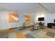Finished basement living area with light gray brick accent wall, modern artwork, and tiled flooring at 1760 Little Willeo Rd, Marietta, GA 30068